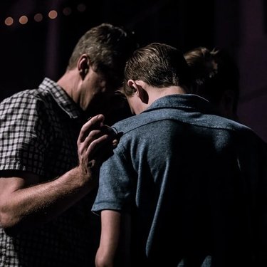 Man comforting another man