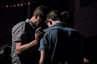 Man comforting another man