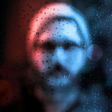 Man behind rain drop window
