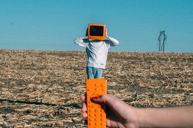 Man with orange TV and remote