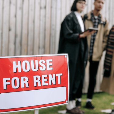 Houses for rent sign with renters
