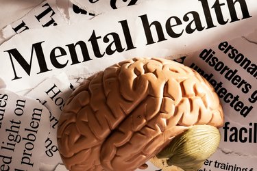 Image of a brain with mental health headlines surrounding