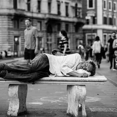 Man lying on bench