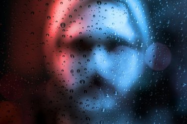 Man behind rain drop window