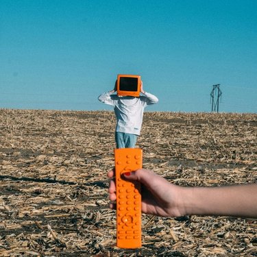 Man with orange TV and remote