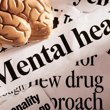 Image of a brain with mental health headlines surrounding