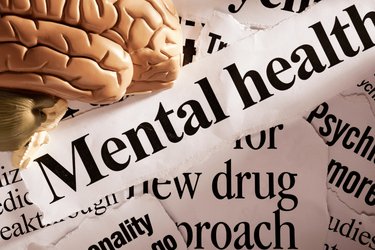 Image of a brain with mental health headlines surrounding